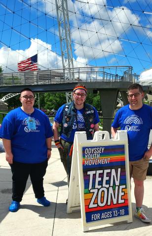 Chandler in friends at OYM event in Spokane, Sign says teen zone.